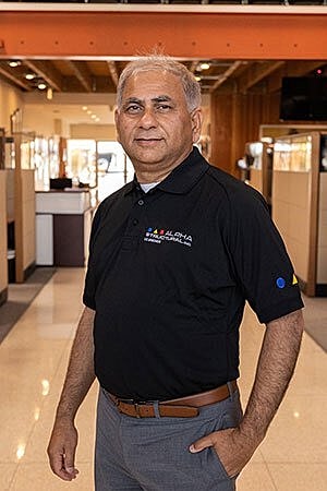Professional man posing in an office setting.