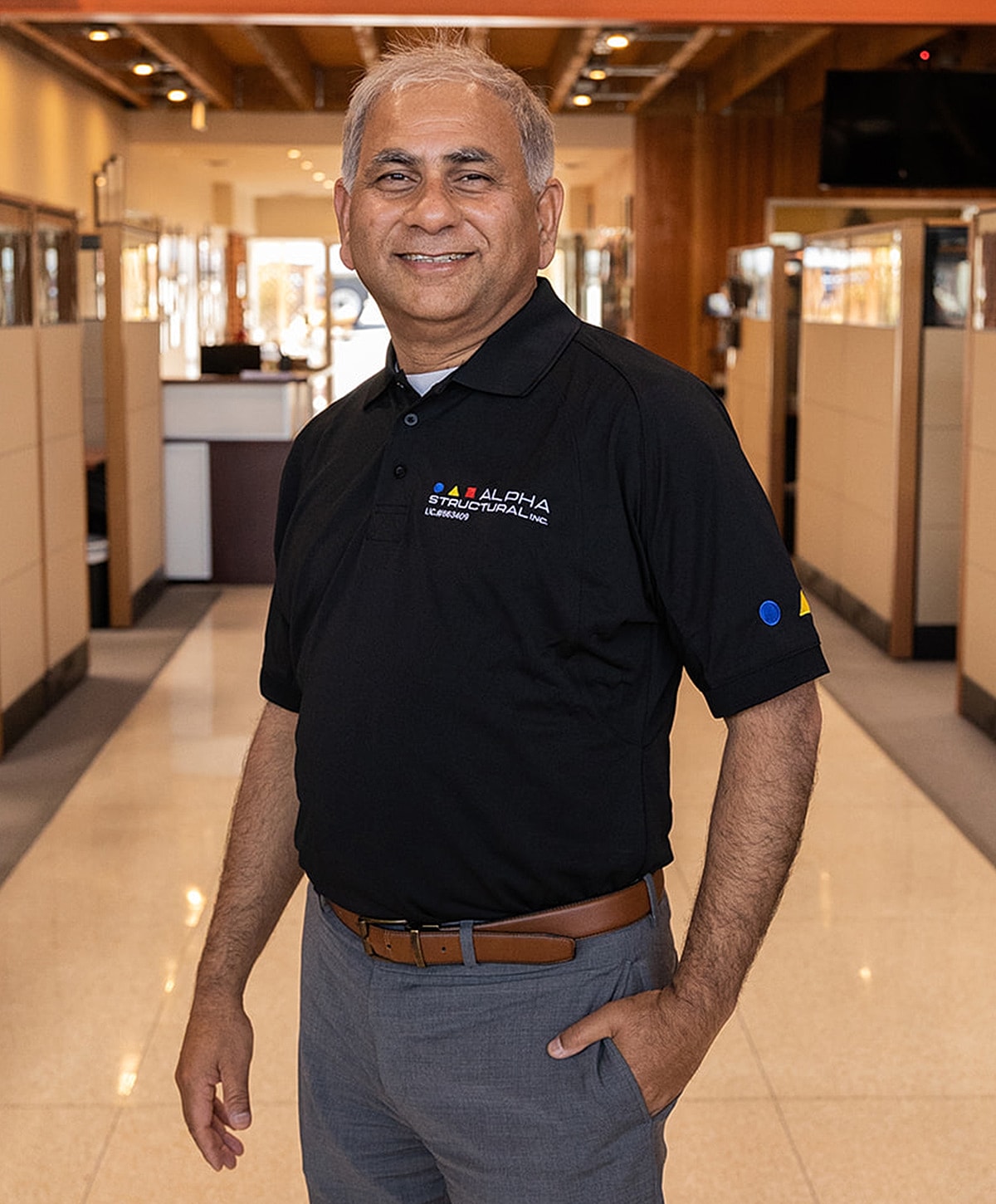 Smiling man in a professional office setting.