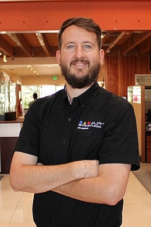 Man smiling in a professional setting.