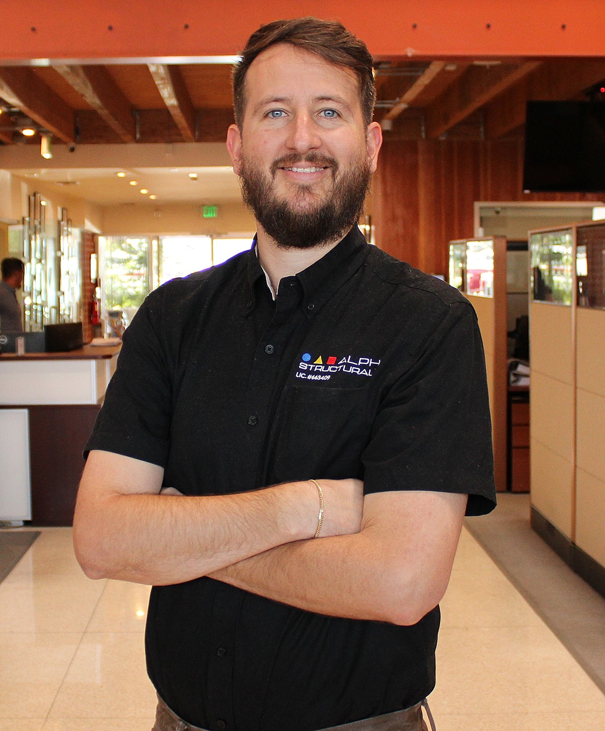 Smiling man in a professional office environment.