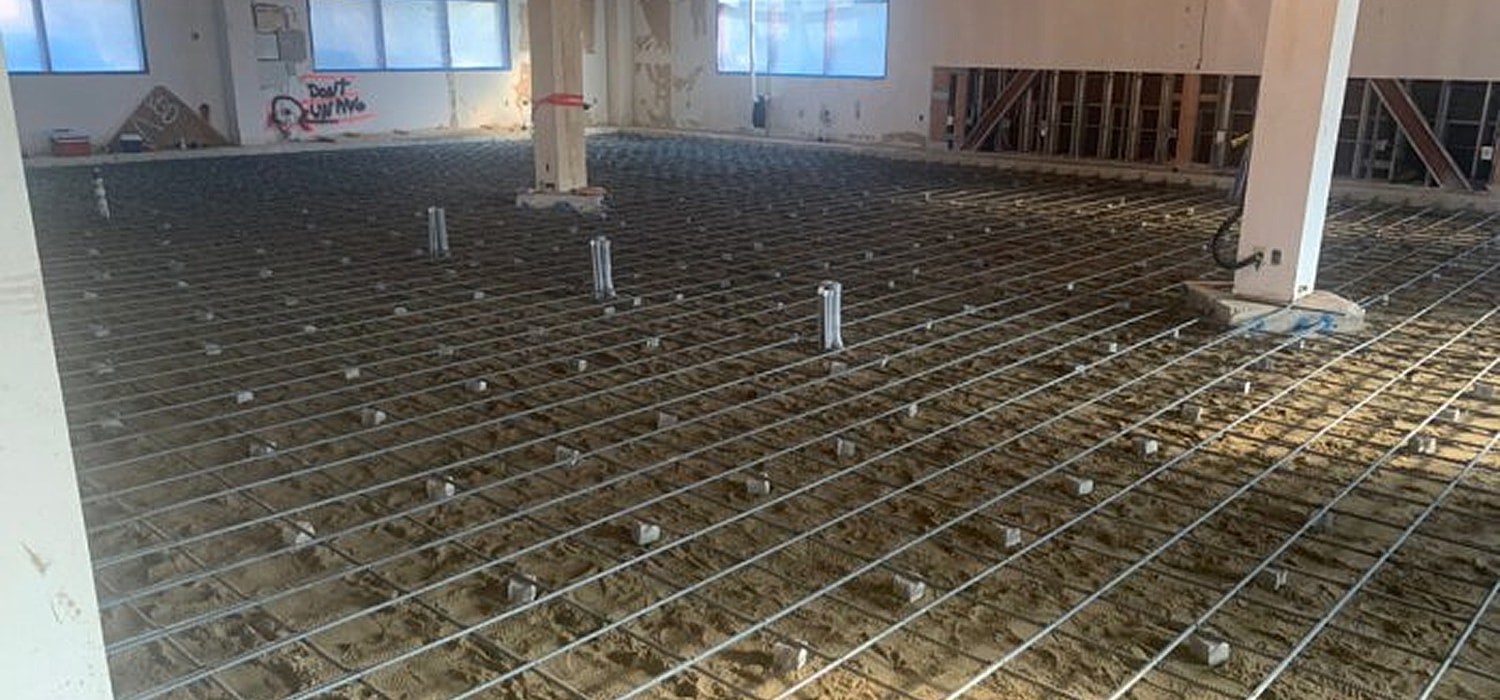 Construction site with exposed sand and reinforcement bars.