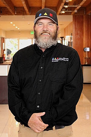 Man in uniform smiling indoors.