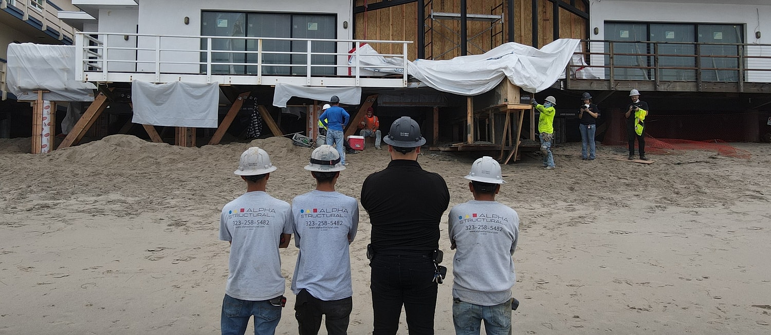 Construction workers overseeing beachfront building project.