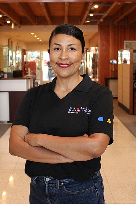Smiling woman in a black polo shirt.