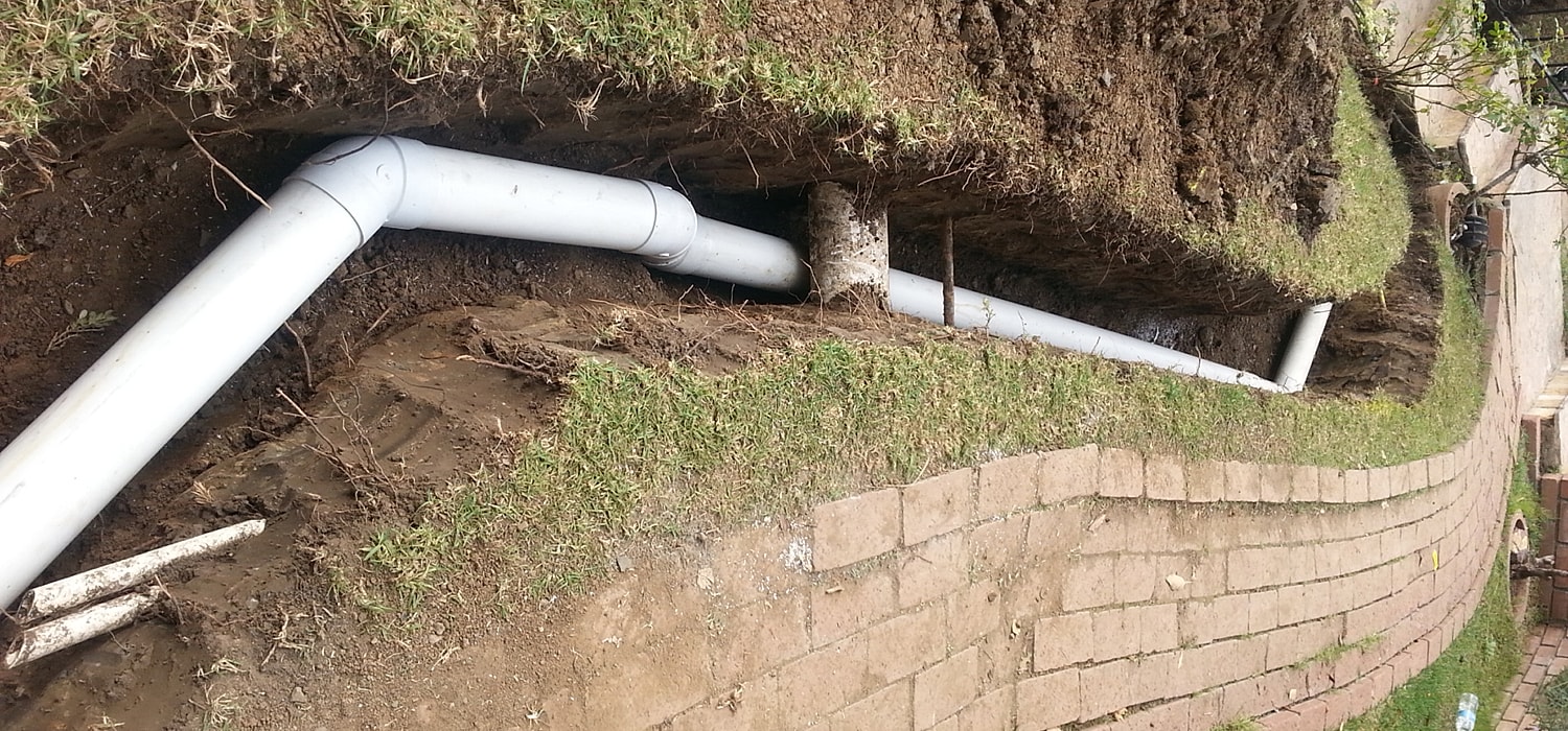 Installed PVC pipes in a trench.