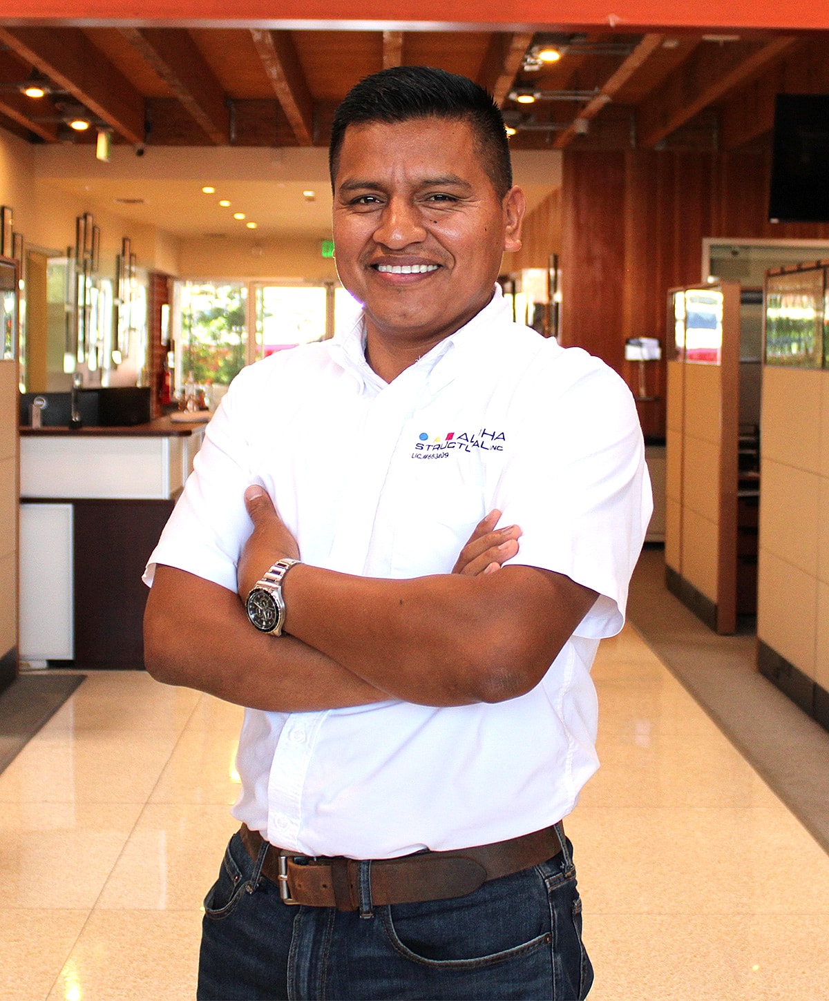 Man in white shirt standing in office.