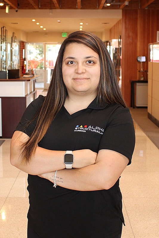 Woman in office uniform standing confidently.