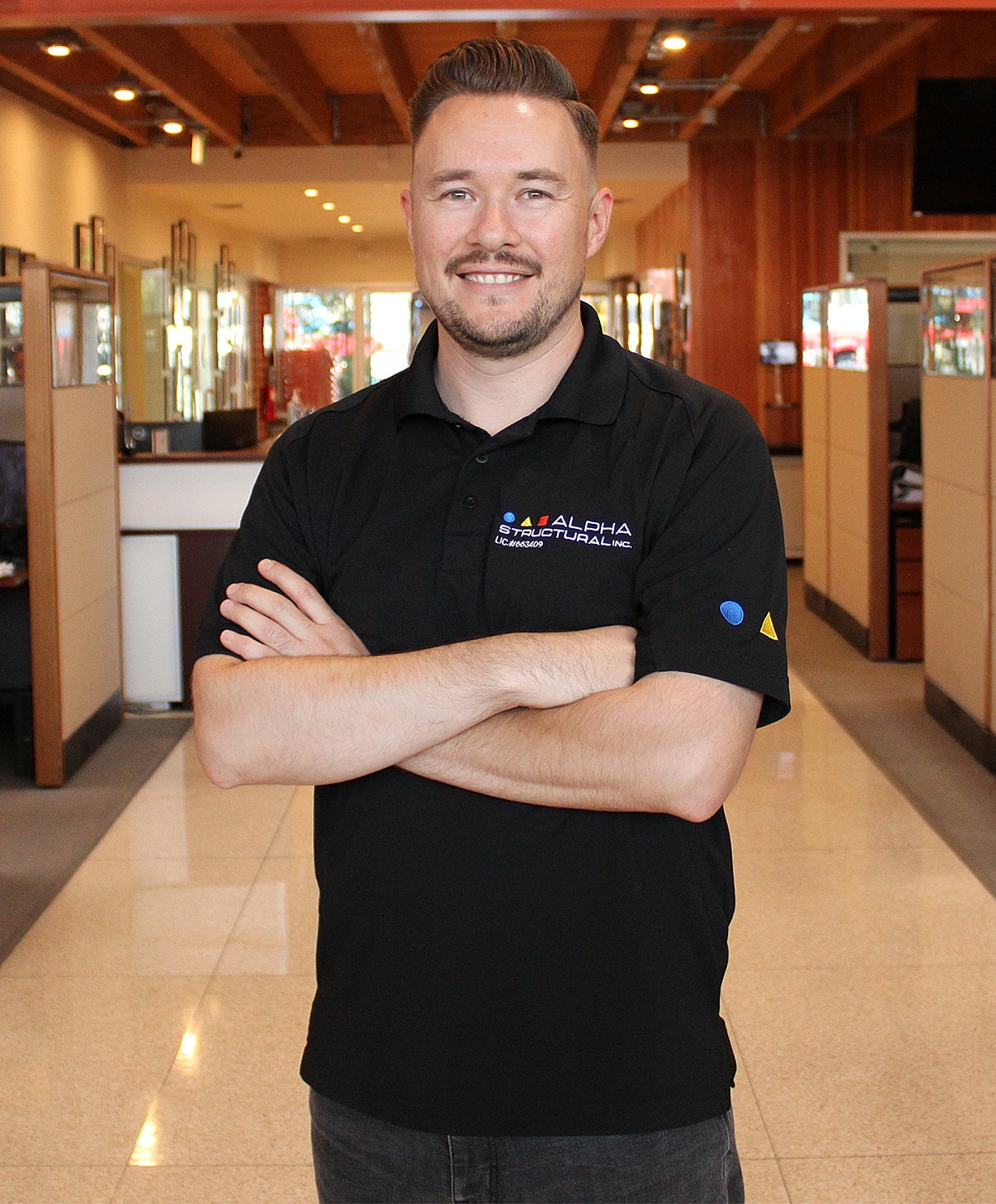 Smiling man in a store setting.