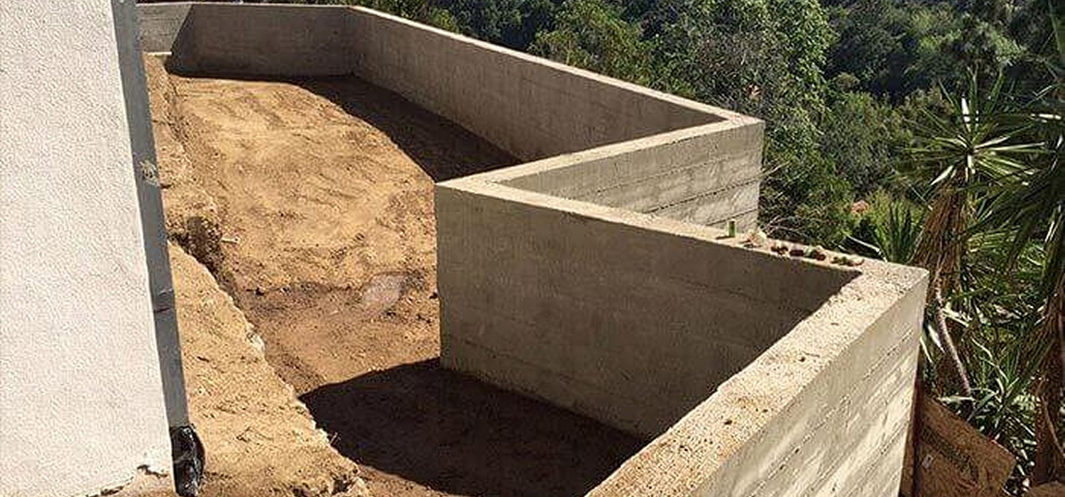 Concrete structure under construction in a landscape.