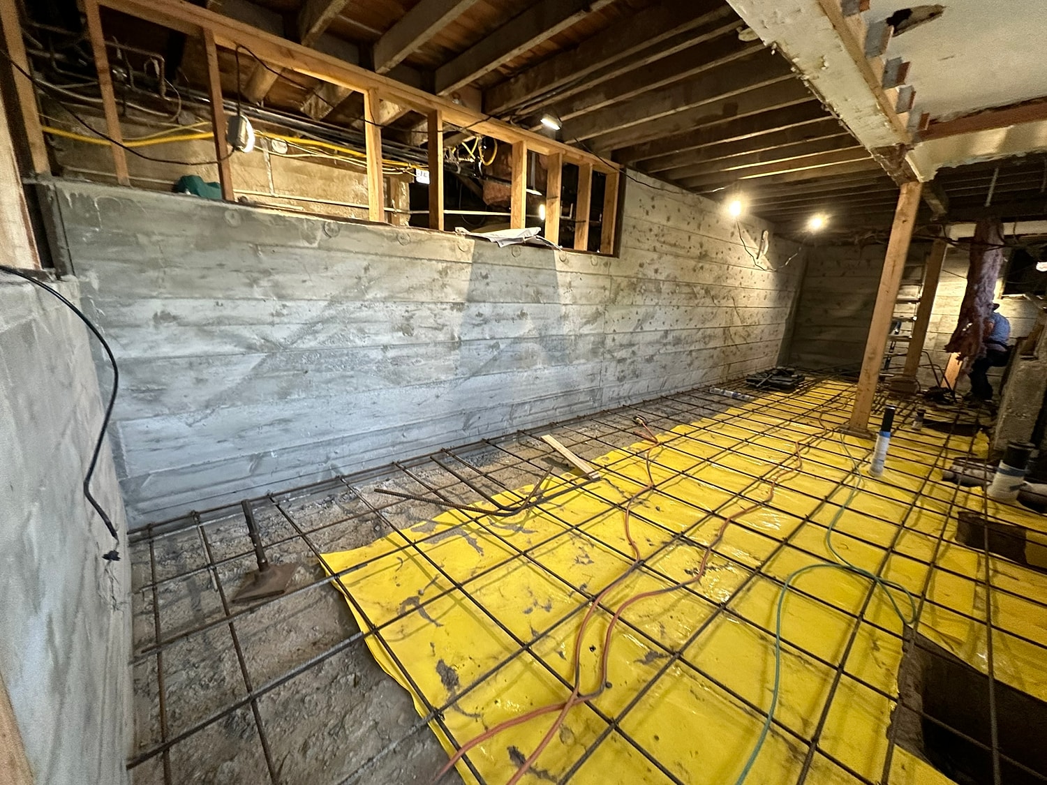 Renovation work in unfinished basement area.