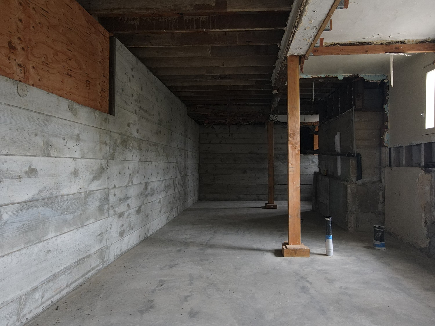 Empty basement under renovation with exposed walls.