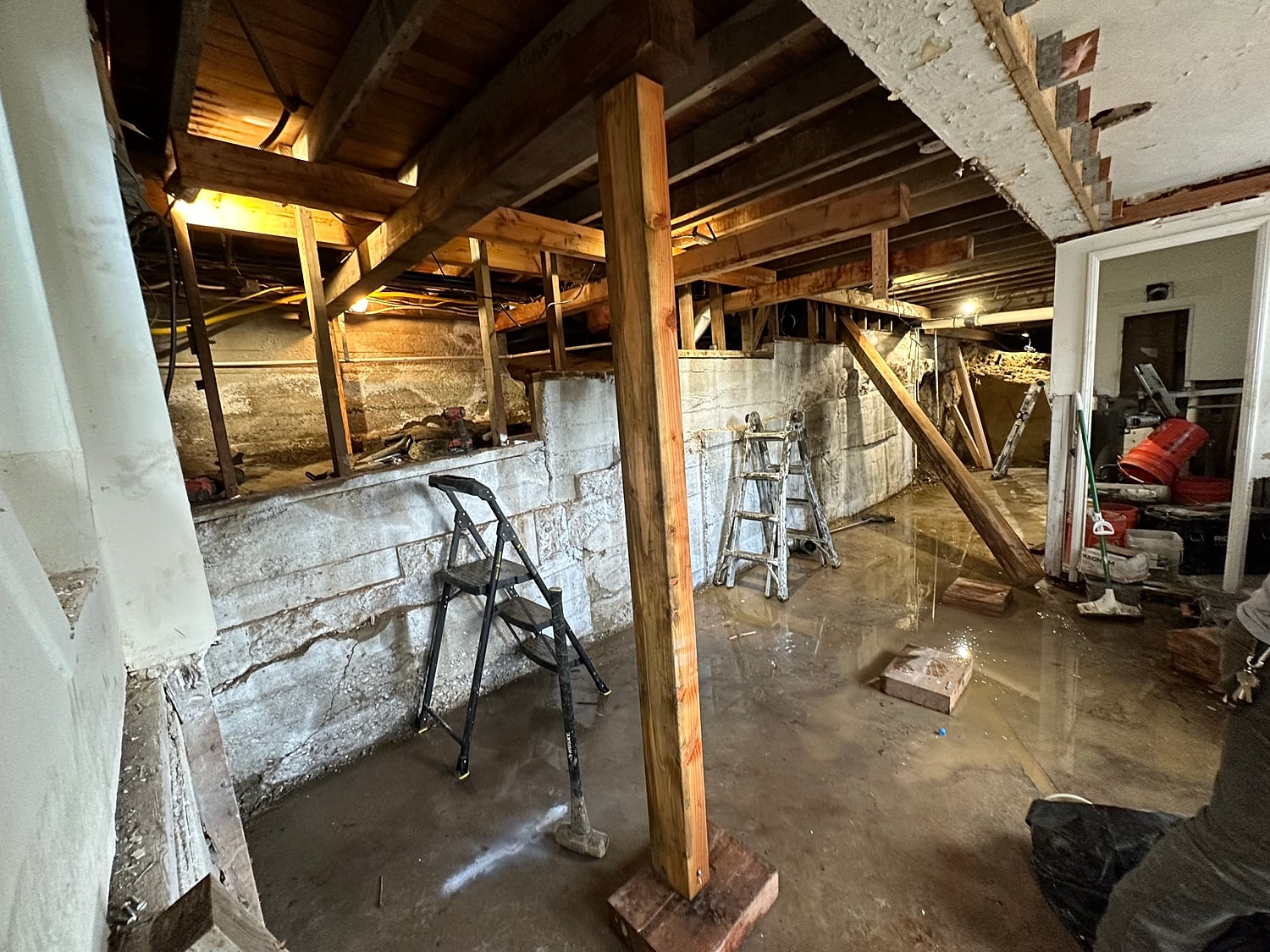 Renovation project in unfinished basement with water.
