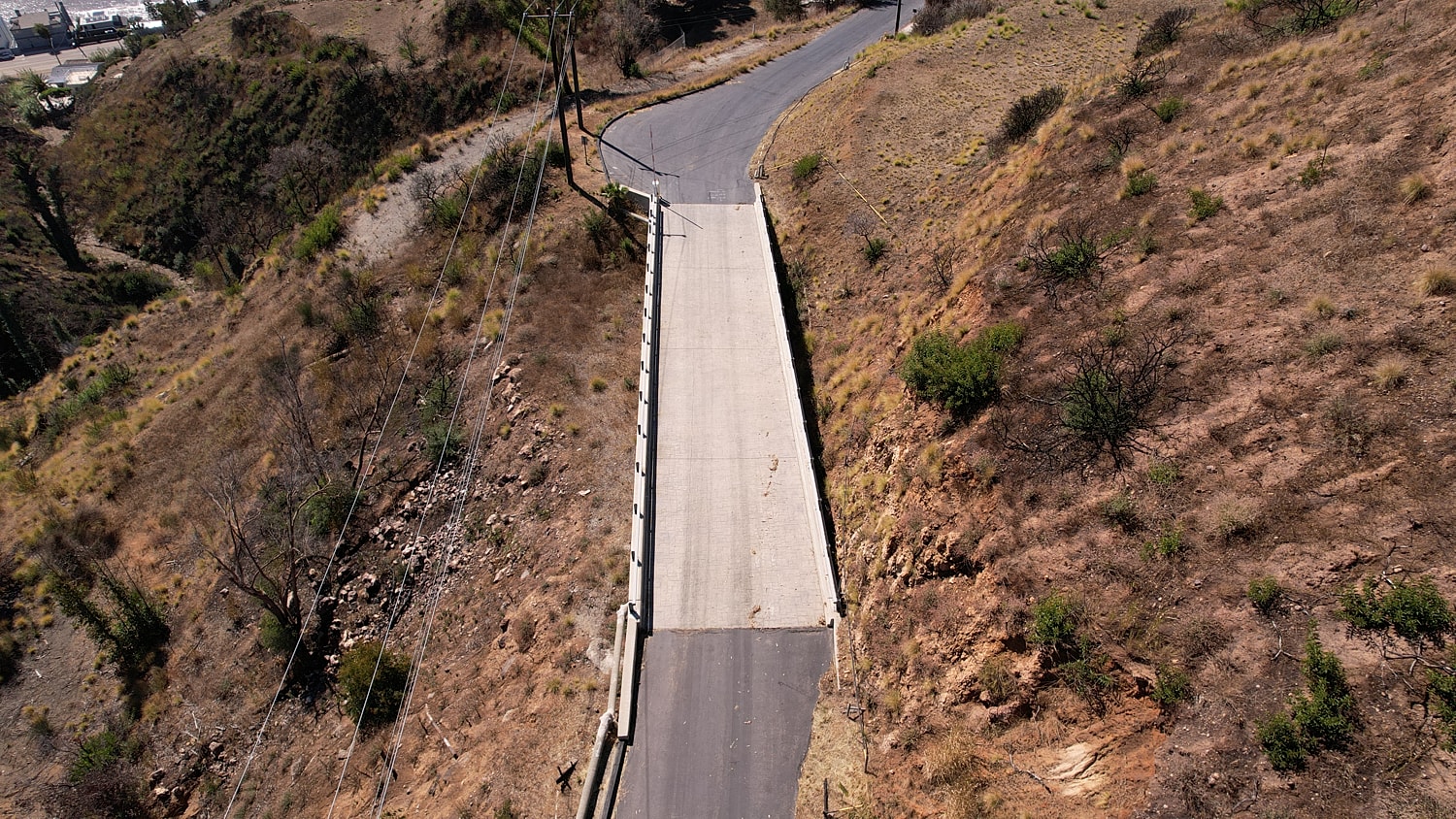Aerial view of winding road on hillside.