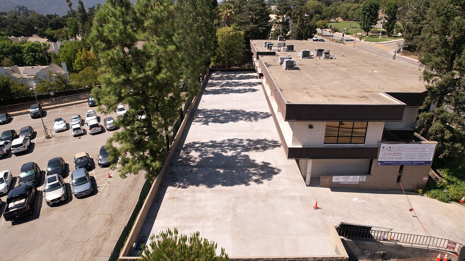 Aerial view of a parking lot and building.