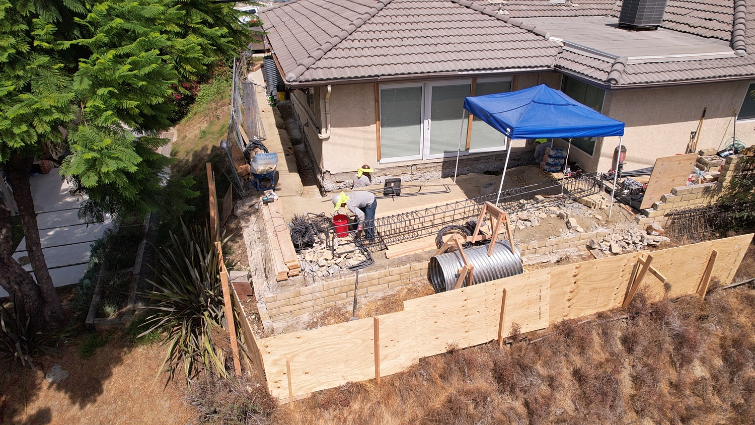 Construction workers performing outdoor renovations.