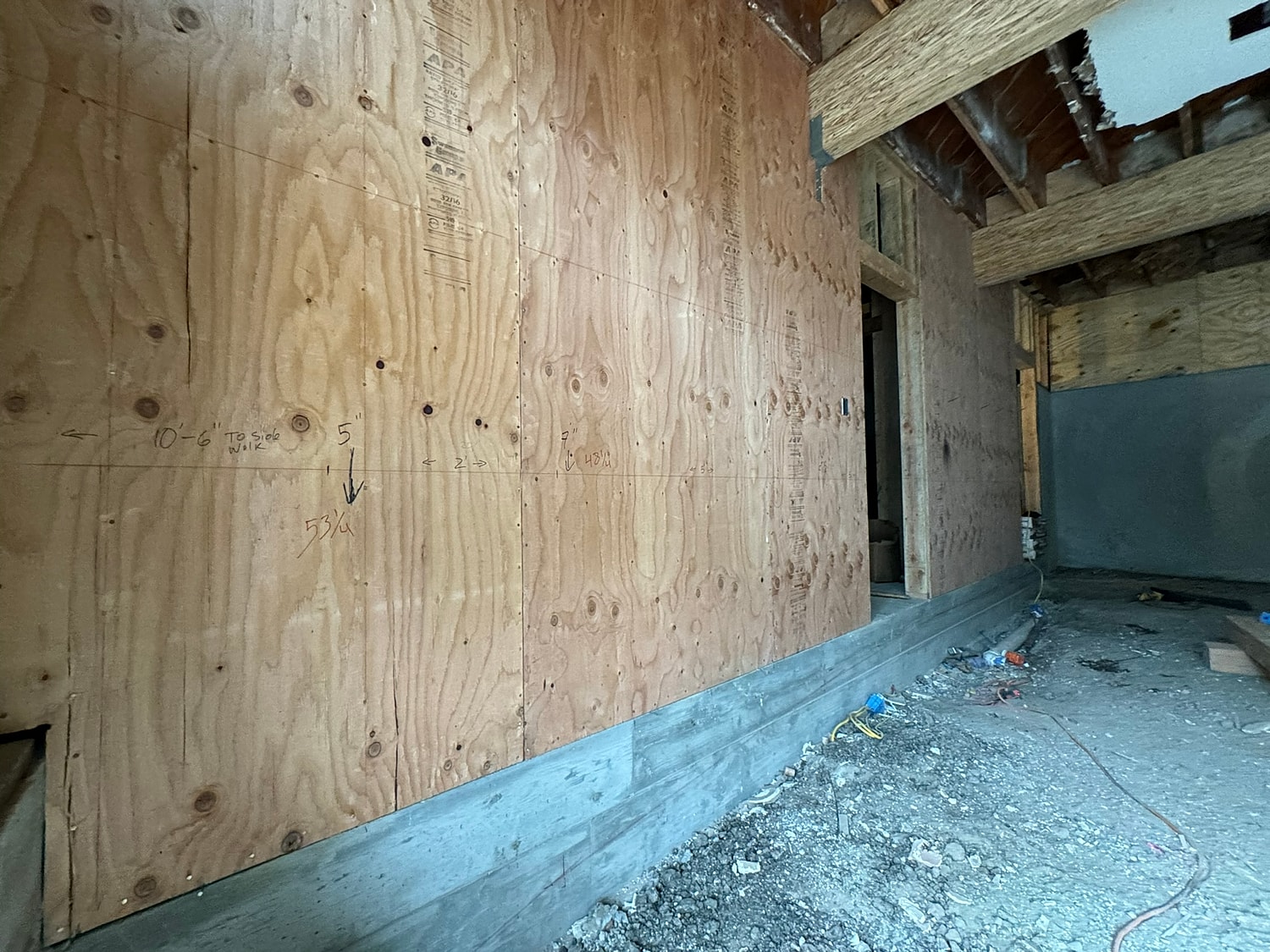 Interior wall with plywood sheathing in construction.