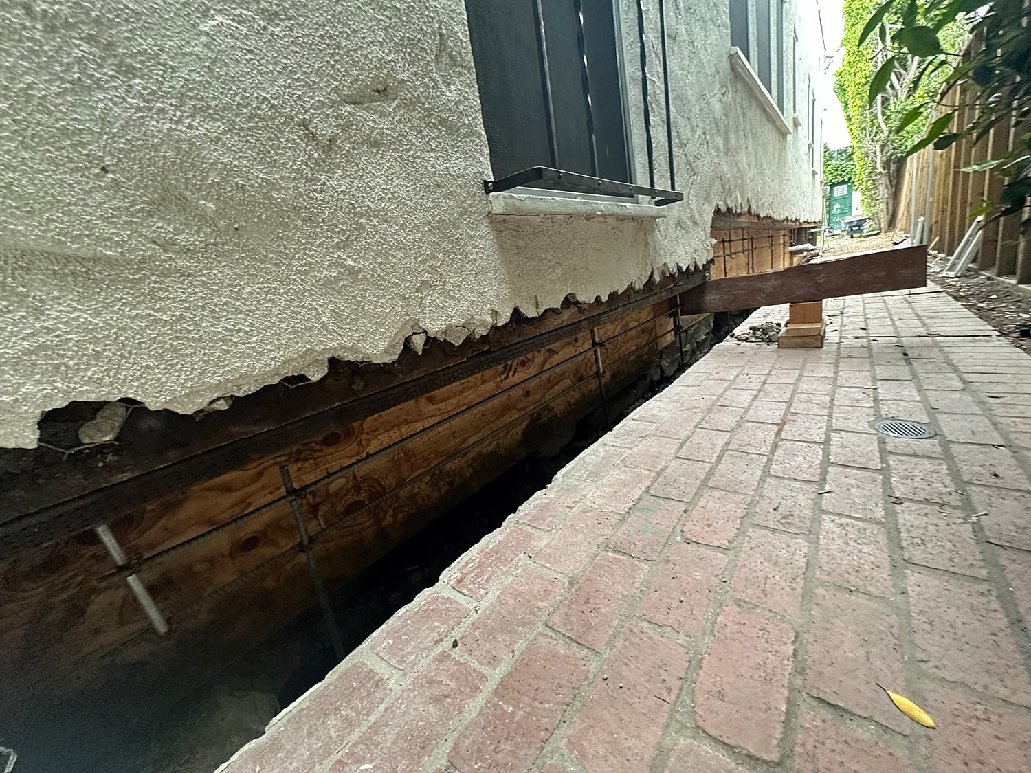 Foundation repair work in progress, with visible damage.