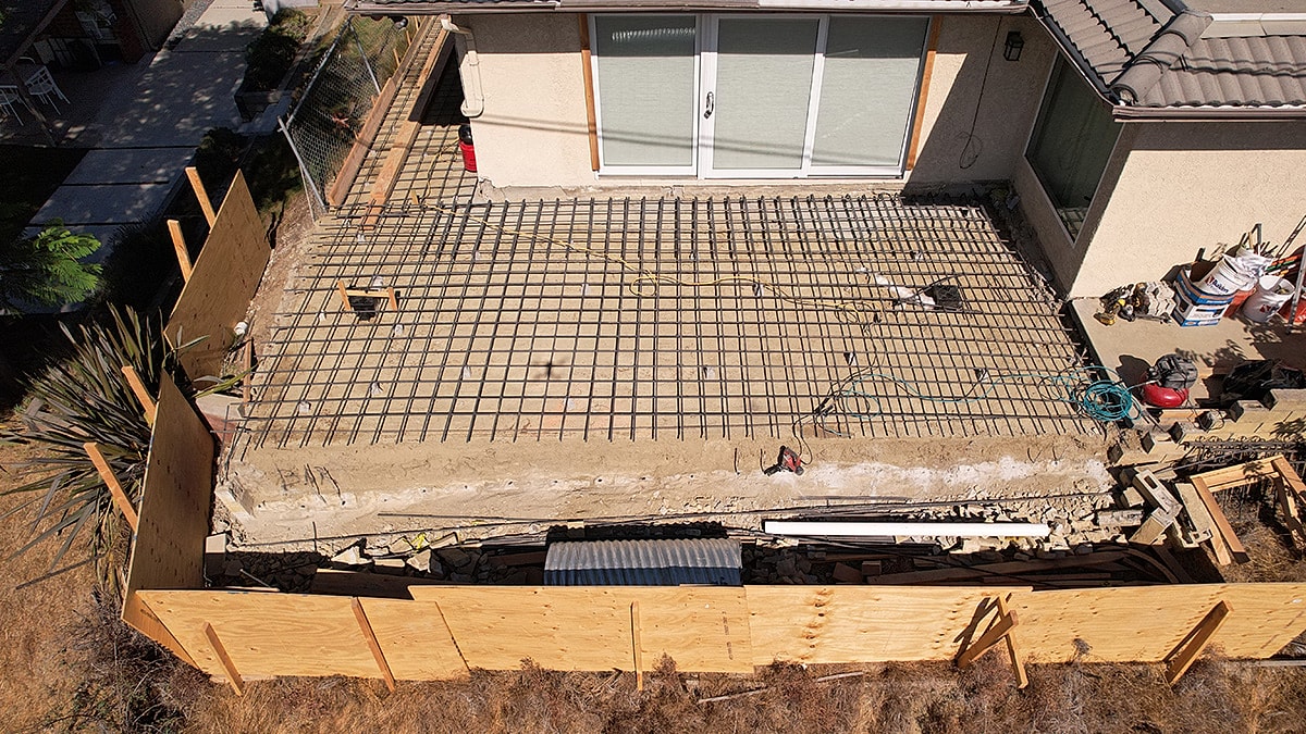 Construction site with rebar and foundation preparation.