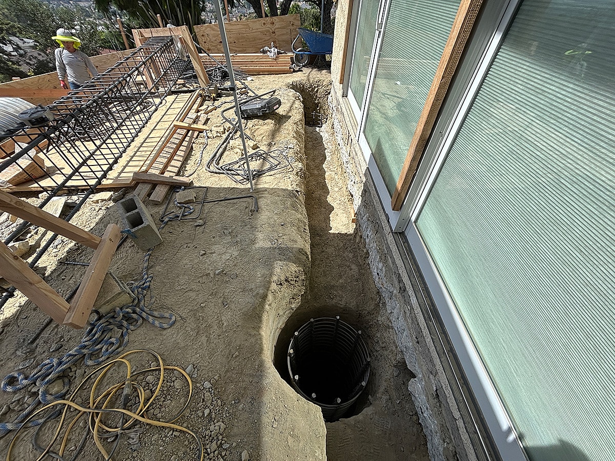 Construction site with a trench and equipment.