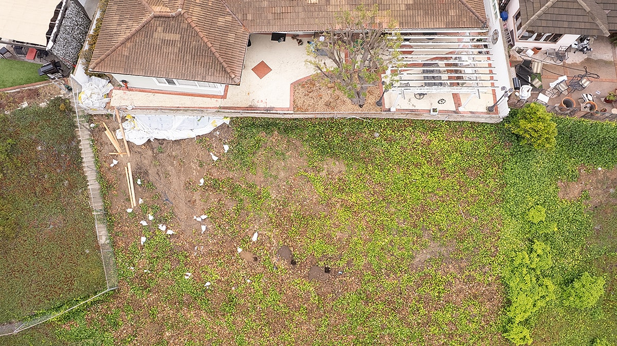 Aerial view of landscaped backyard and house.