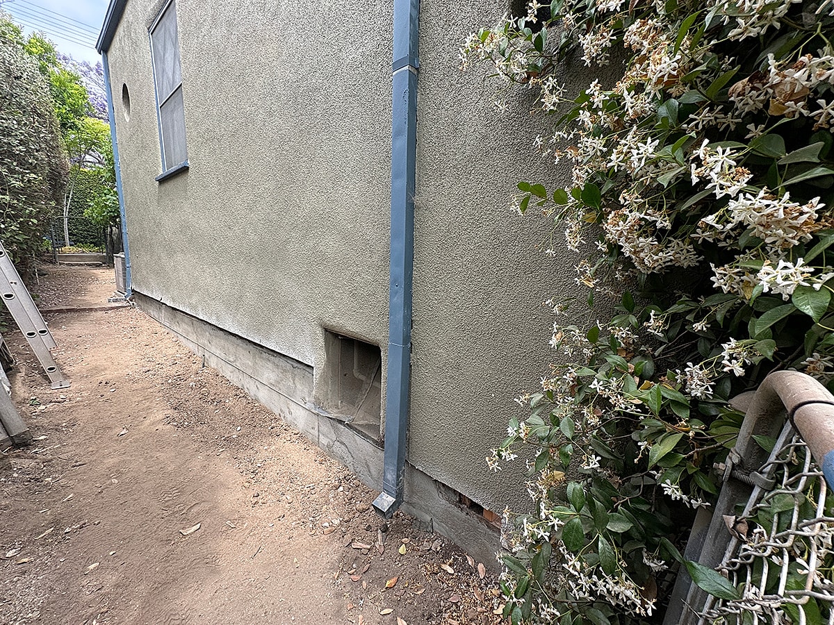 Side view of a house with flowers.