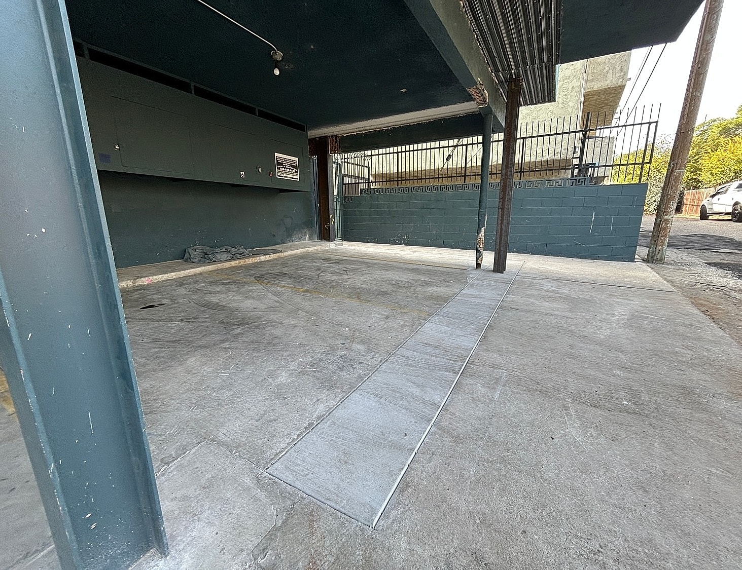 Underground parking area with concrete walls and floor.