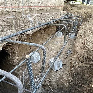 Concrete foundation with steel rebar installation.
