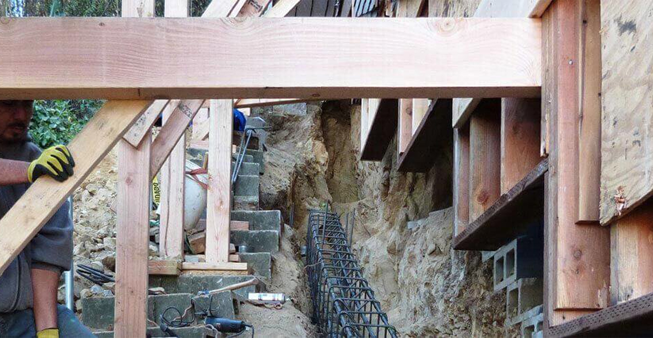 Construction site with wooden beams and foundation work.