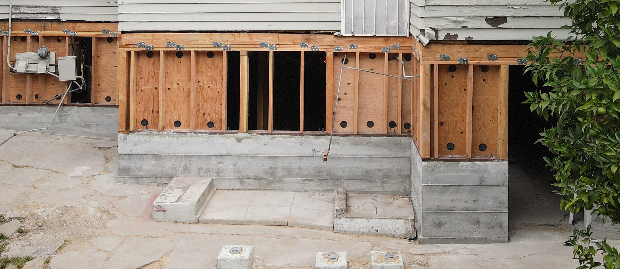 House foundation under construction with exposed walls.