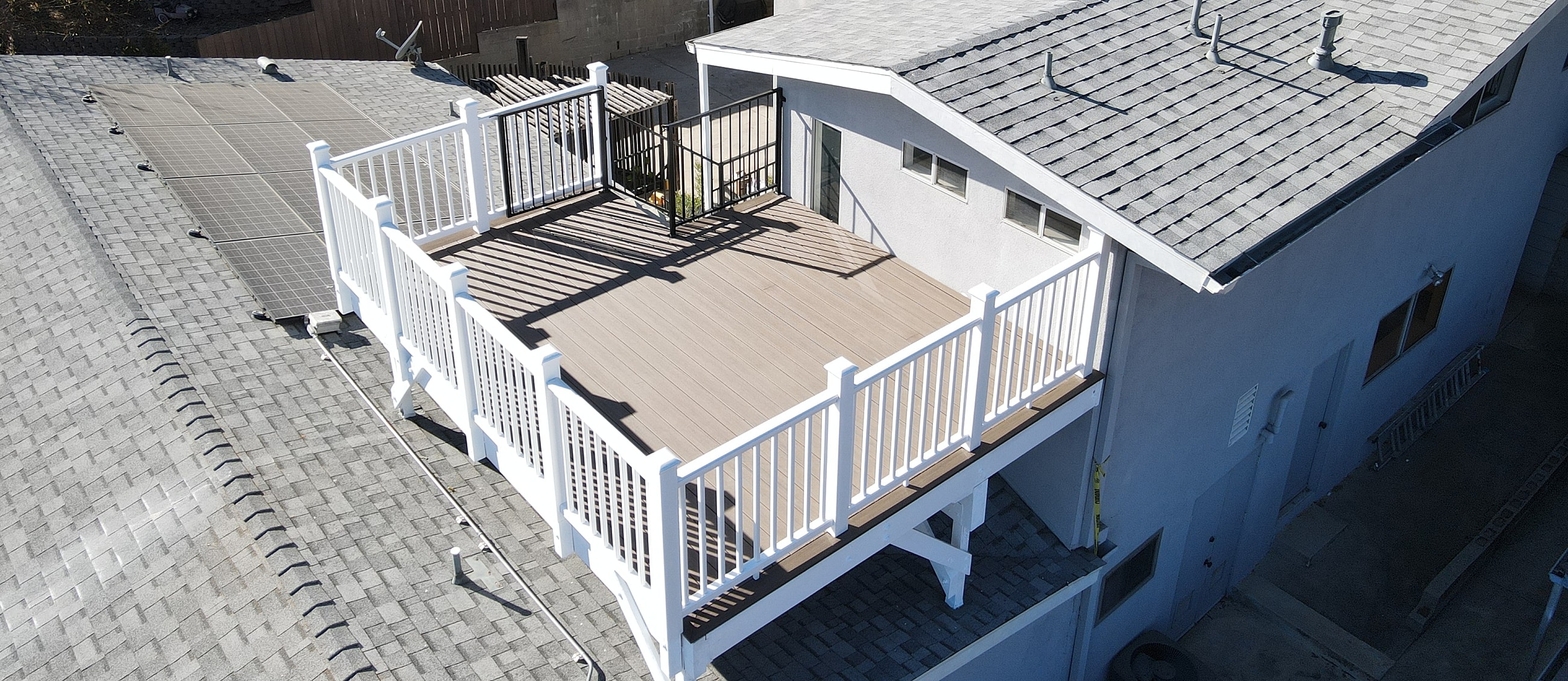 Aerial view of rooftop deck with railing.