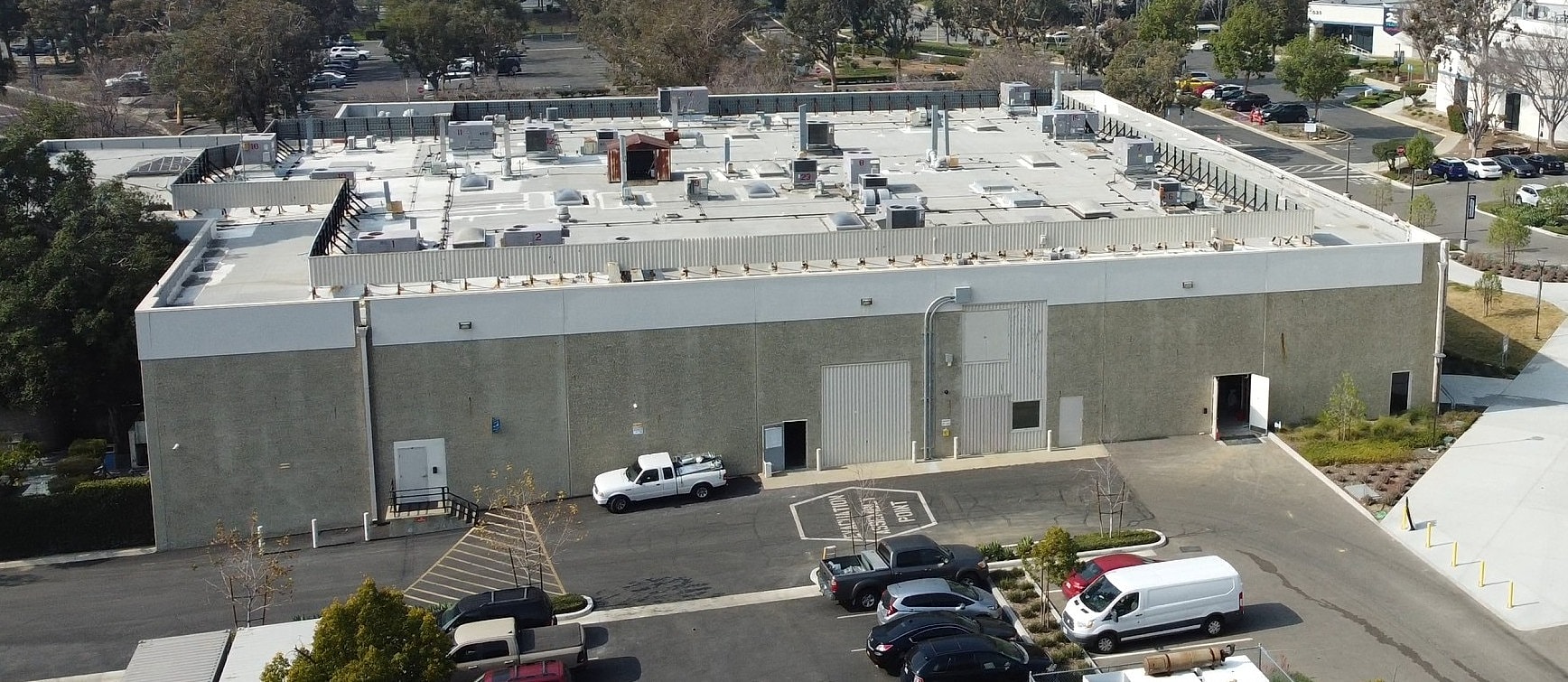 Aerial view of a commercial building and parking.